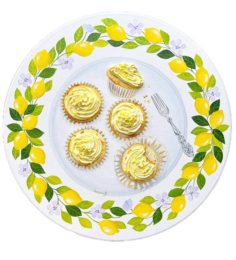 Painting lemon cupcakes on a plate