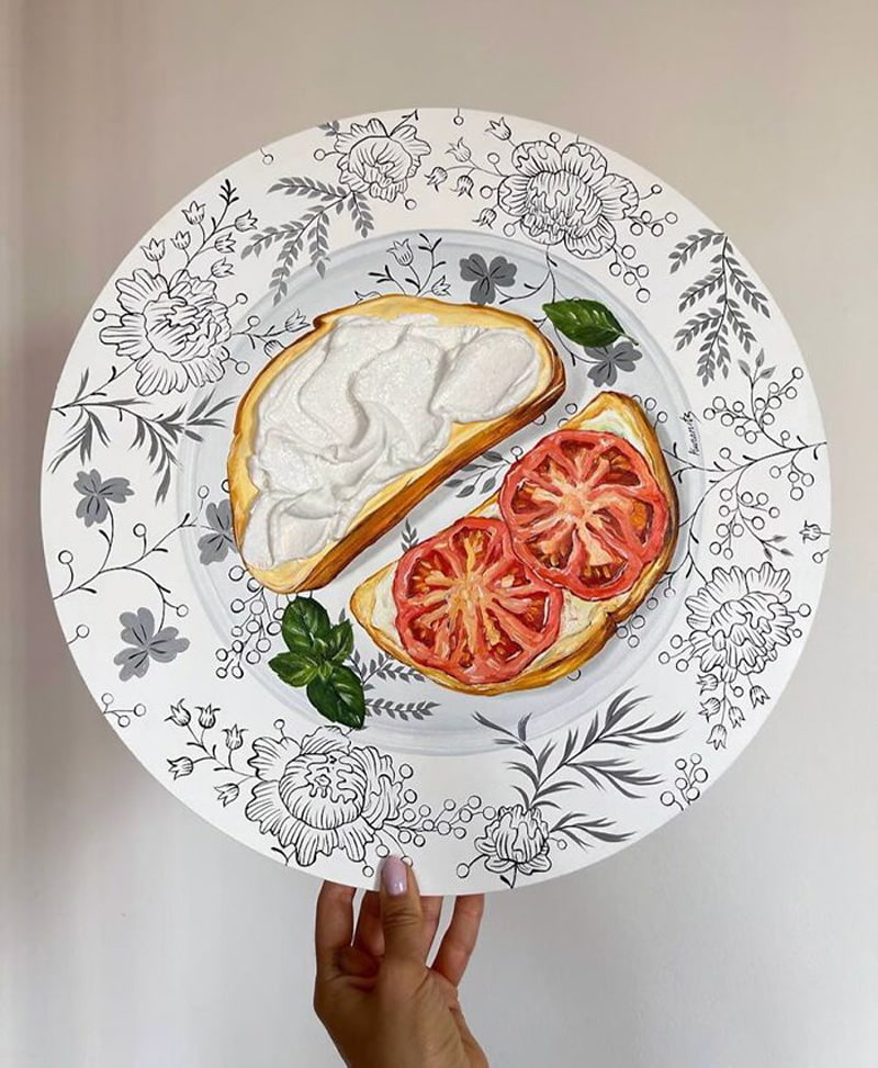 Bread, cheese and tomato painted on the plate
