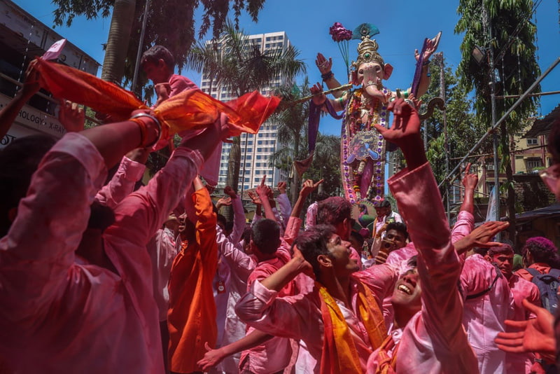Carrying Hindu idols to the sea for worship and immersion in the water in Bombay, India