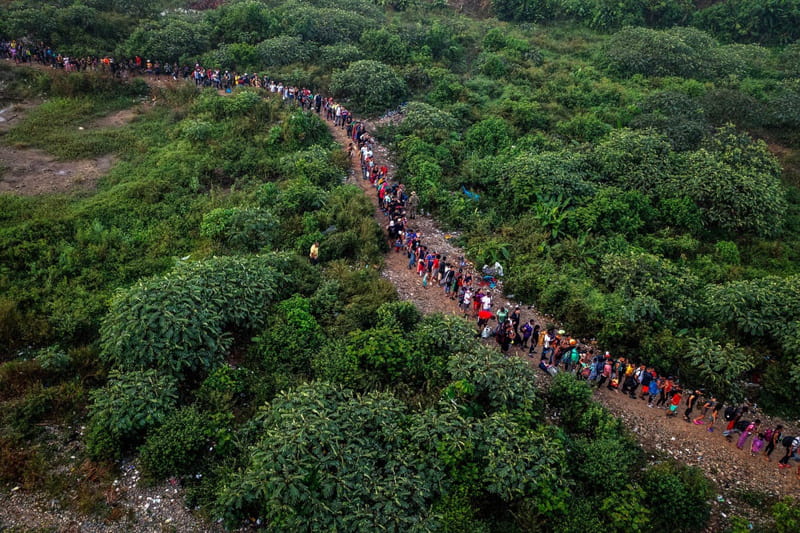 Immigrants move on the Darien Gap road on the way to <a href=