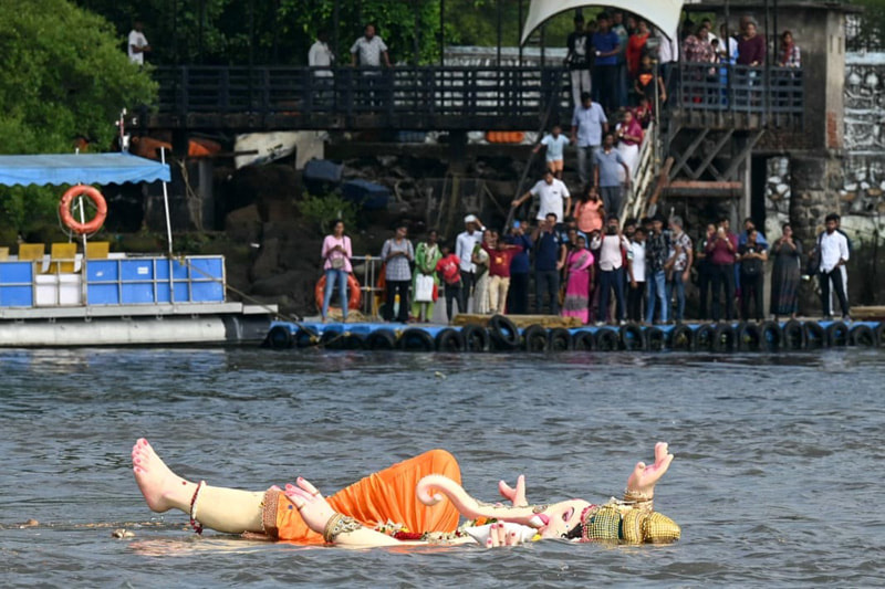 Floating the idol of the Hindu god Ganesha in the Arabian sea, after the end of the Ganesh Chaturthi festival. 
