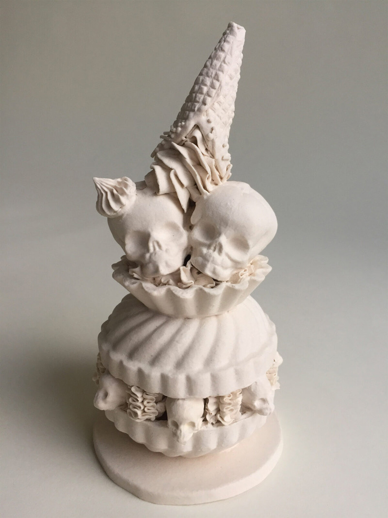 Eclair and skull porcelain figurine