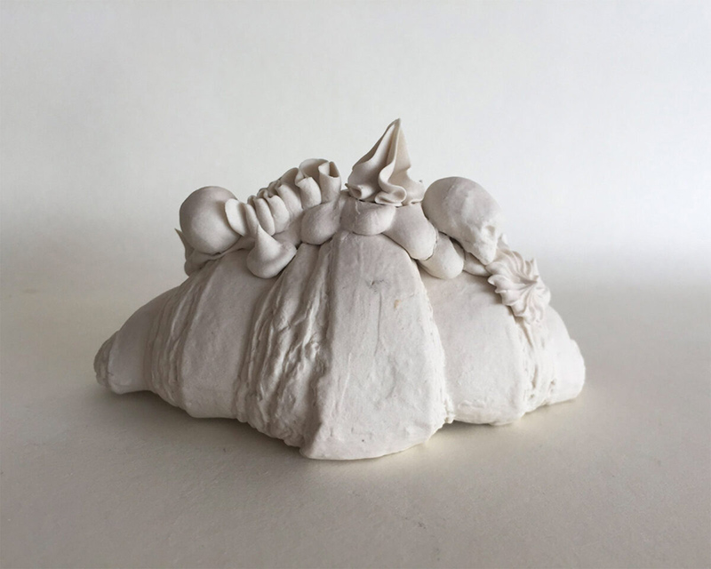 Croissant and skull porcelain figurine
