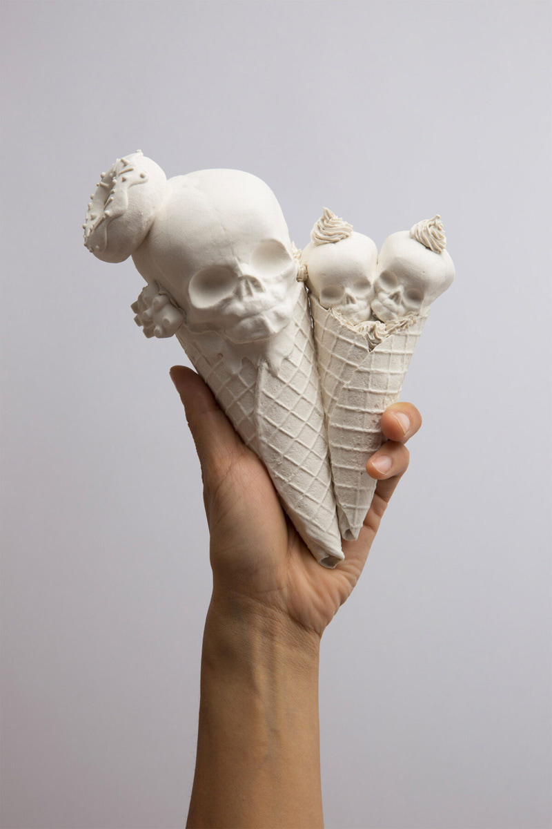 Statue of two skull ice cream cones in hand