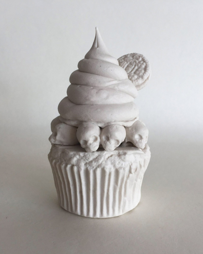 Porcelain skull cupcake figurine