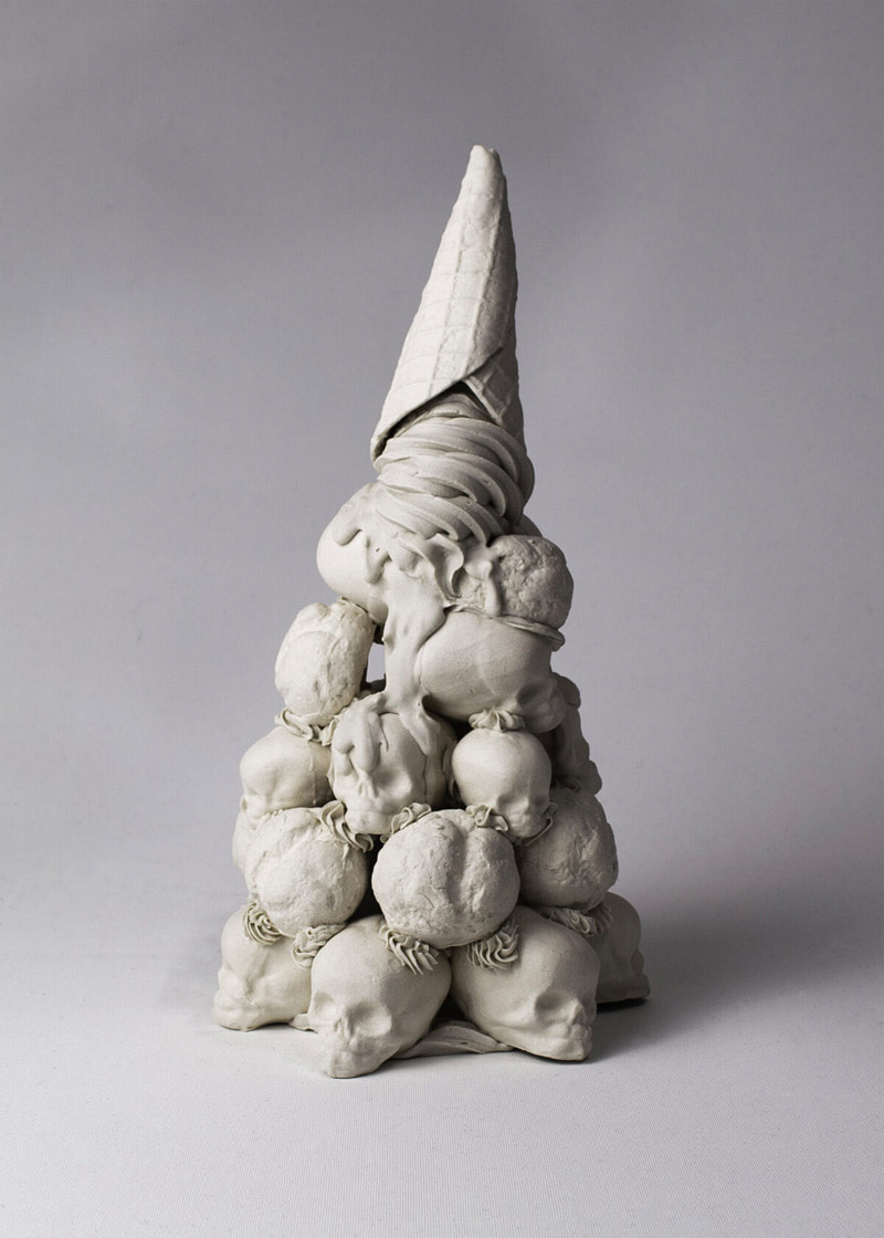 An ice cream cone sculpture turned on a skull hill