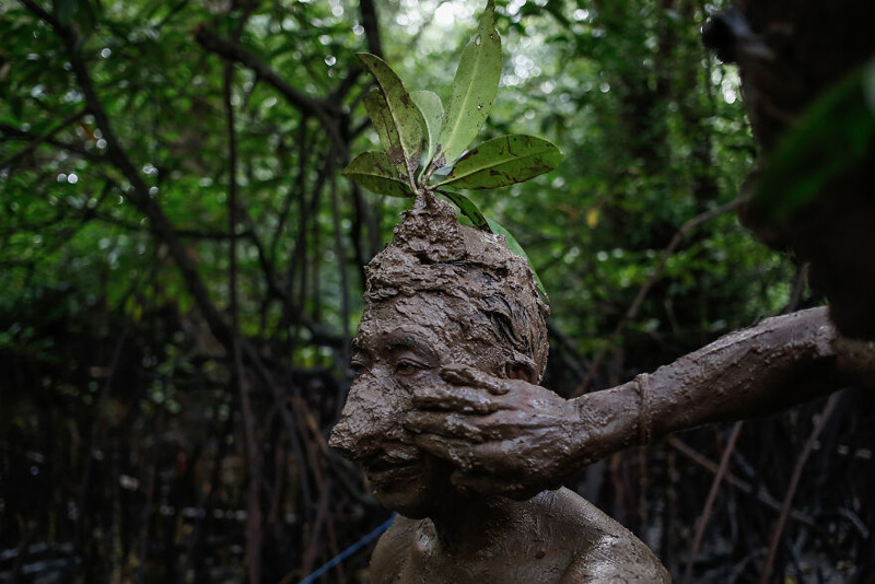 Mud bath ritual in the mangrove forests of Indonesia