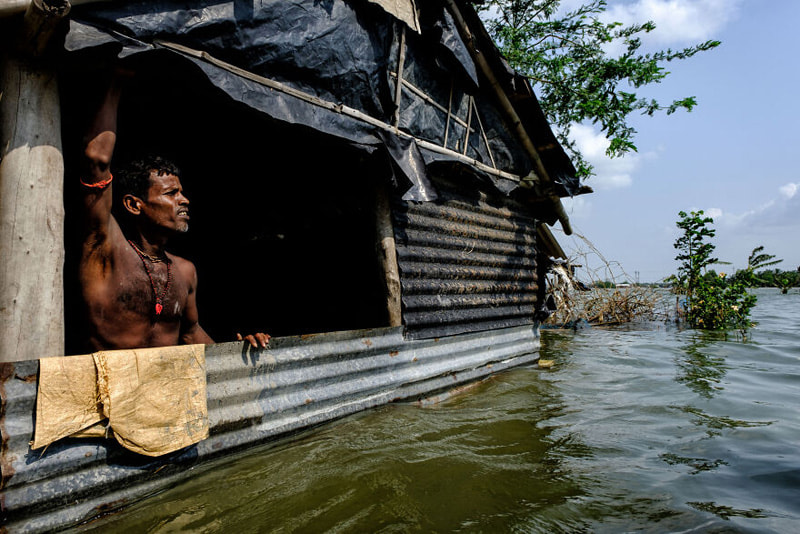 Villager's semi-submerged house in Indian floods