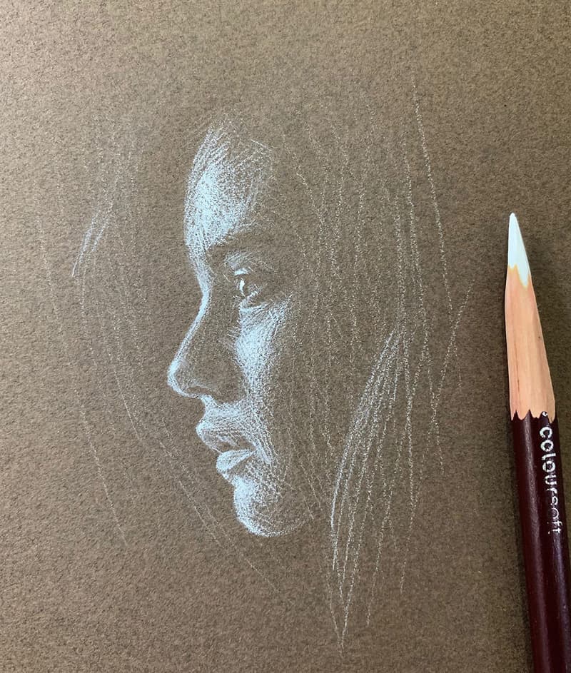 Drawing the profile of a little girl with a white pencil
