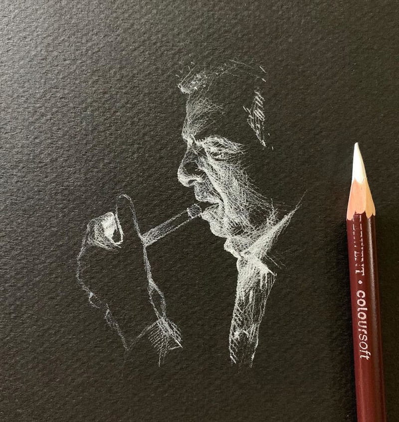 A profile drawing of a man with a pipe in white pencil