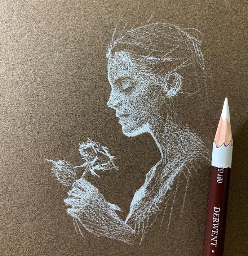 A drawing of a girl with a flower in her hand with a white pencil