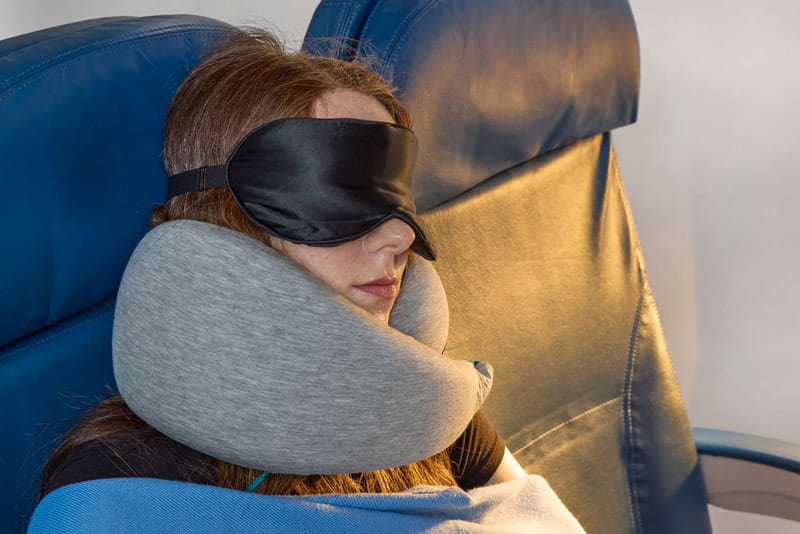 Sleeping with a blindfold and a neck pillow on the plane, photo source: travel eisure website, photographer: unknown