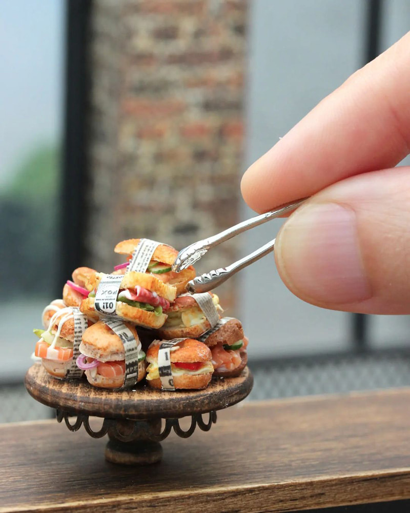 A container of miniature sandwiches made by Shai Aaron