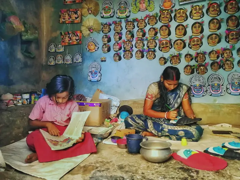 Indian mother and child in handicraft workshop