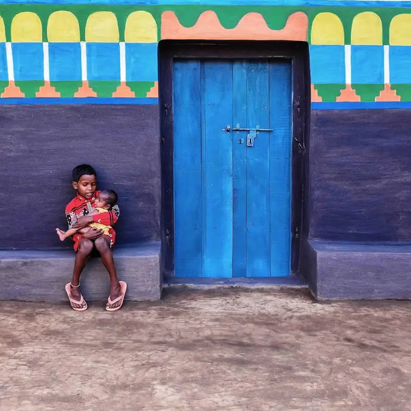 Indian child next to a colorful wall