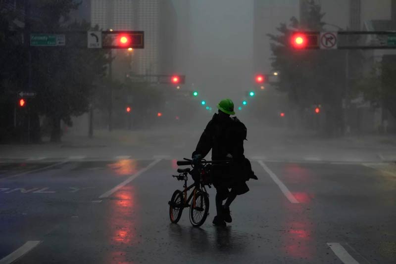 Cyclist through the streets of Florida during Hurricane Milton; Photo source: npr.org website; Photographer: Rebecca Blackwell