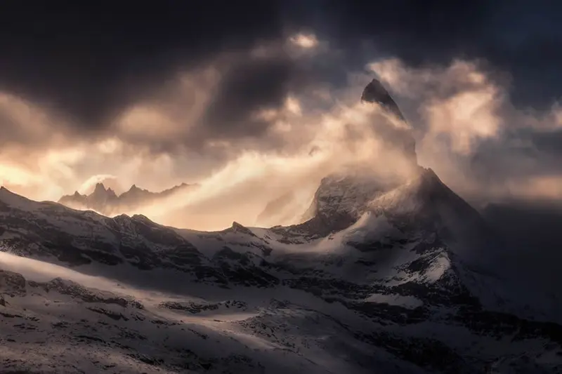 Snowy Alps covered in clouds and fog