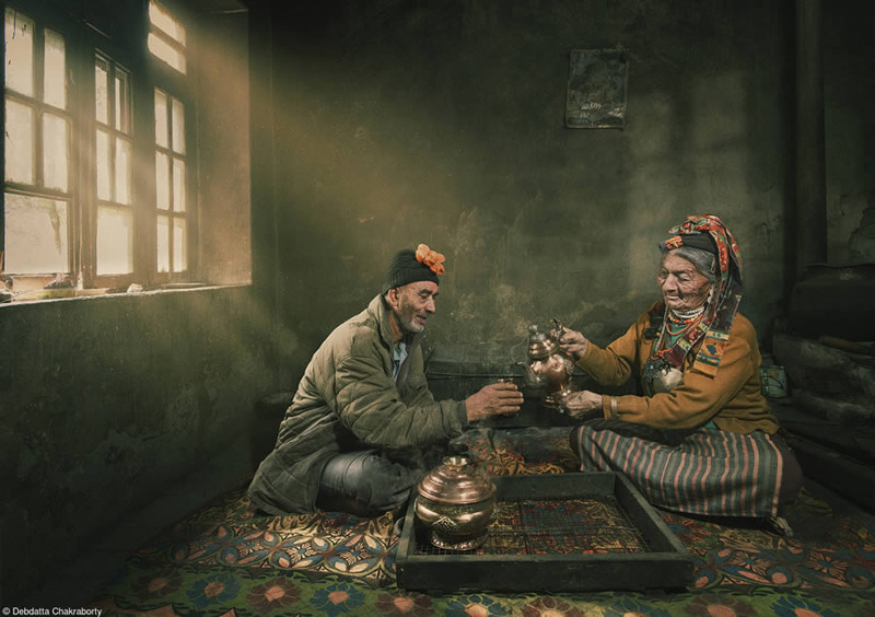 Village man and woman drinking tea