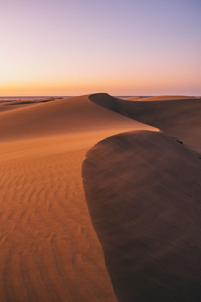 The shadow of the sun on the sand dunes of Spain