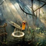 Asian fisherman in the forest river