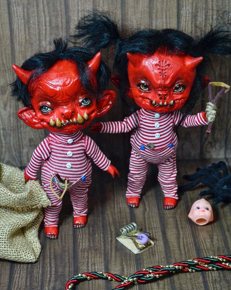 Two Halloween dolls with fiery red faces