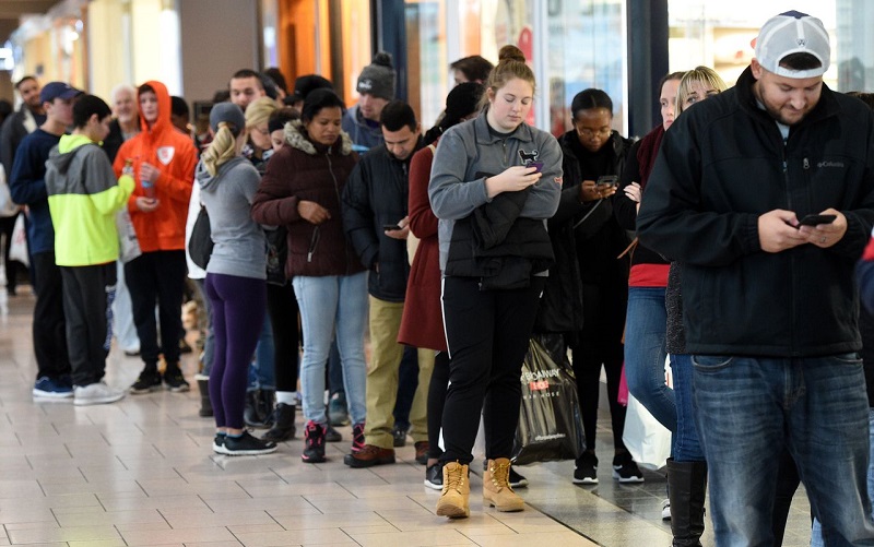 People in long lines shopping at Black Friday auctions