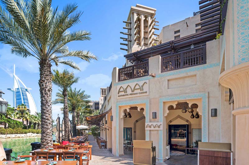 Entrance of Pomegranate restaurant and view of Burj Al Arab, Dubai; Photo Source: Dubai Review, Photographer: Unknown