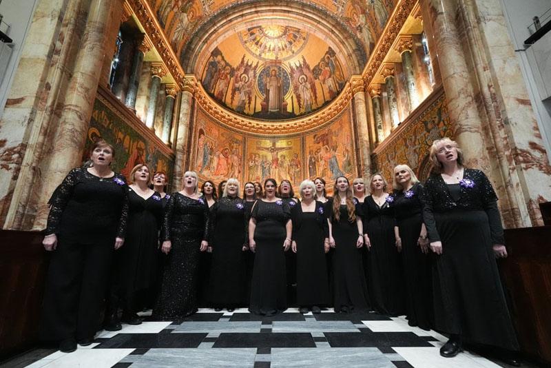 The performance of the singers of the Military Wives Choir on the 76th birthday of King Charles III in a church in London; Photographer: Lucy North 