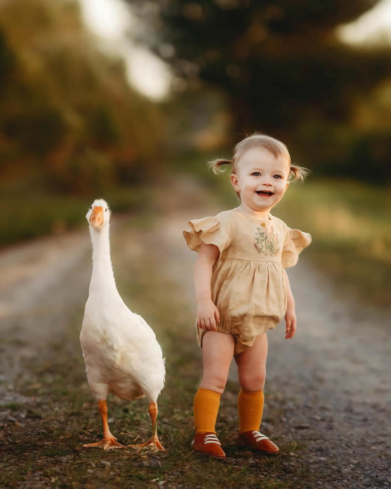 Little girl and goose on the road