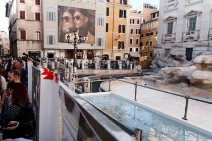 Temporary pool for throwing coins in the fountain of Troy, Italy