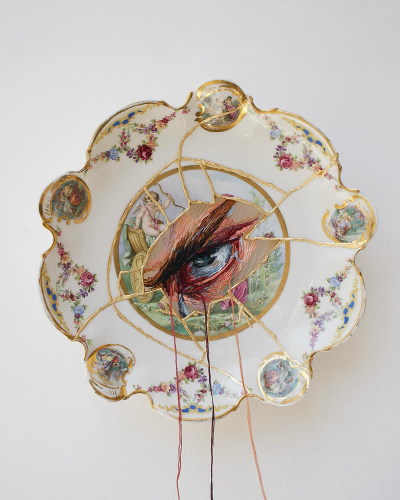 White porcelain plate with embroidery and eye design