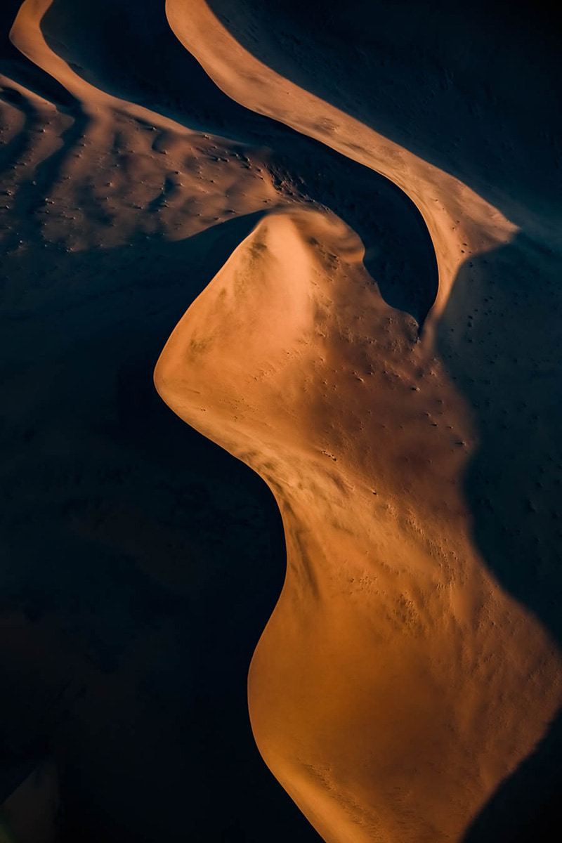 The wavy lines of the sands of the Namib desert in the golden light