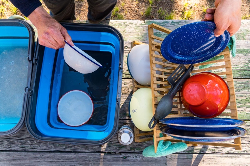 washing dishes in nature; Photo source: www.freshoffthegrid.com. Photographer: Unknown