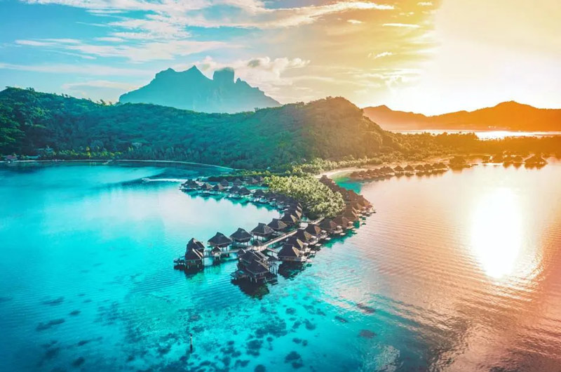Aerial photo of houses on the water of Bora Bora islands; Photo Source: Forbes, Photographer: Unknown