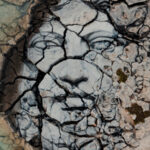 Painting of human face on stone ground