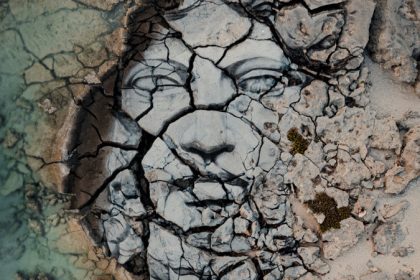 Painting of human face on stone ground