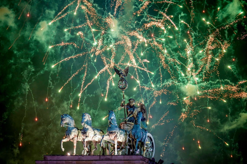   Brandenburg Gate during New Year celebrations in Berlin, Germany; Photo source: guardian; Name of the photographer: Ebrahim Nowrozi