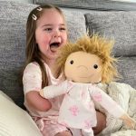 A little girl with a golden hair doll