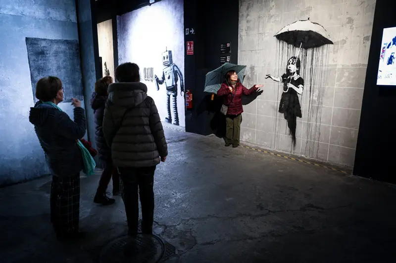 People in a museum of Banksi's works in Madrid