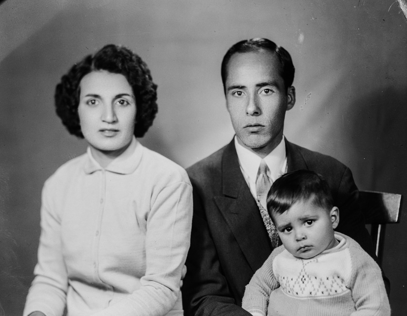 Black photo of young couple and their child in ancient Iran