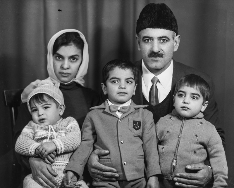 Parents of children in the camera frame of the old photographer