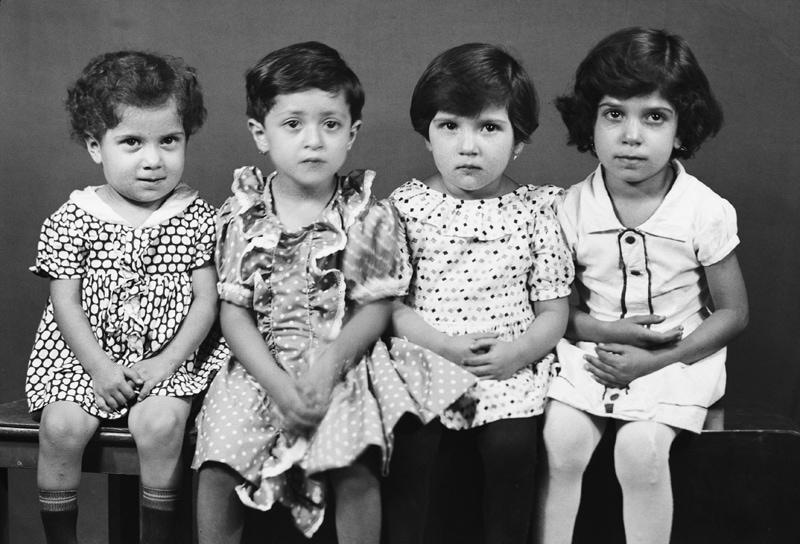 Black photo of four children in ancient Iran