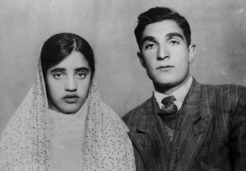 The young couple in the camera frame of the old photographer