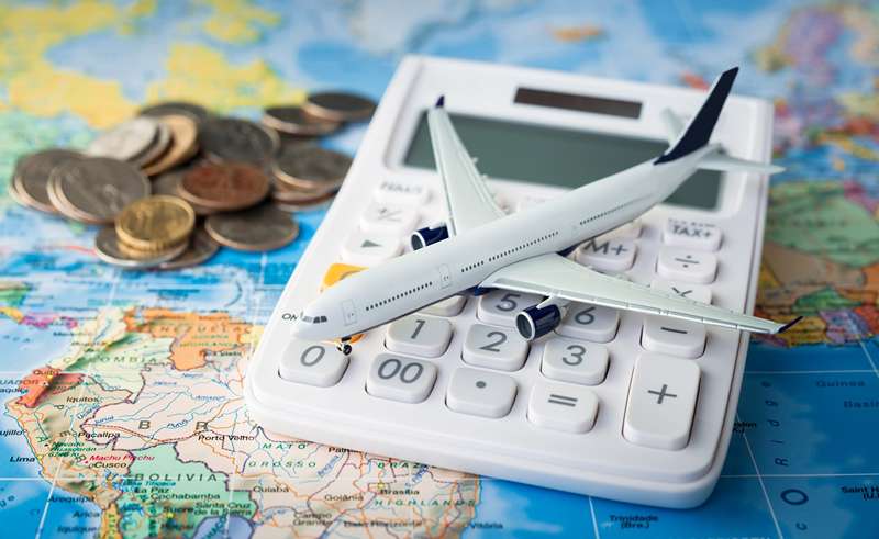 Calculator with aircraft replica, Photo Source: Getty Images, Photographer: Unknown