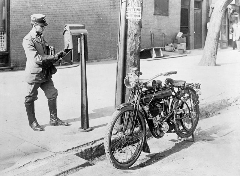 Black and white photo of the postman in the past; Photo Source: Britannica; Photographer's name: Unknown