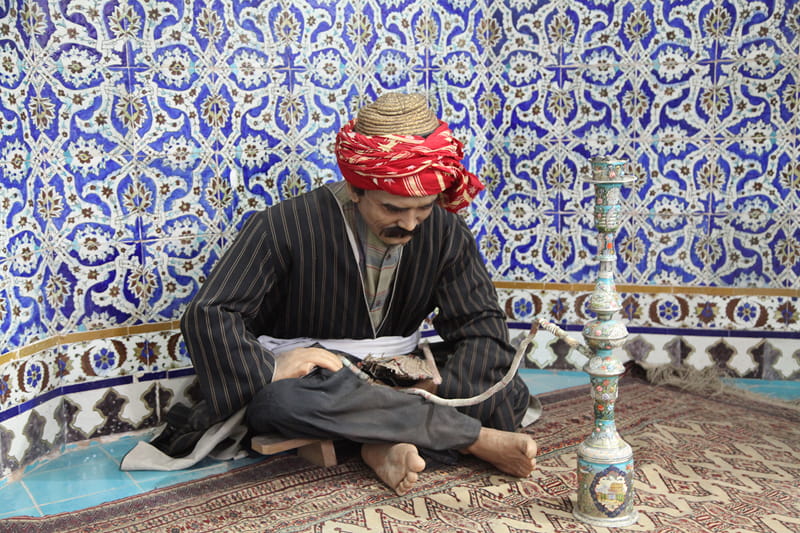 Statue of a man with red and hookah in the bathroom of Ganjali Khan Kerman; Photographer: Mohammad Shojaee