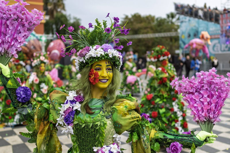 A woman at the Flower Battle event in Carnival City Nice, France; Photo Source: Theguardian; Photographer's name: Unknown