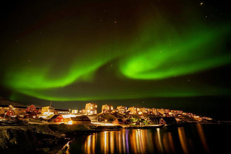 North Aurora over the capital of Novok Island, Greenland; Photo Source: Theguardian; Photographer Name: Emilio Morenatti