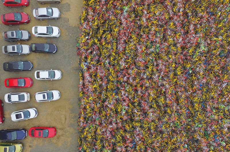 Thousands of bicycles abandoned in the parking lot in China; Photographer: Unknown