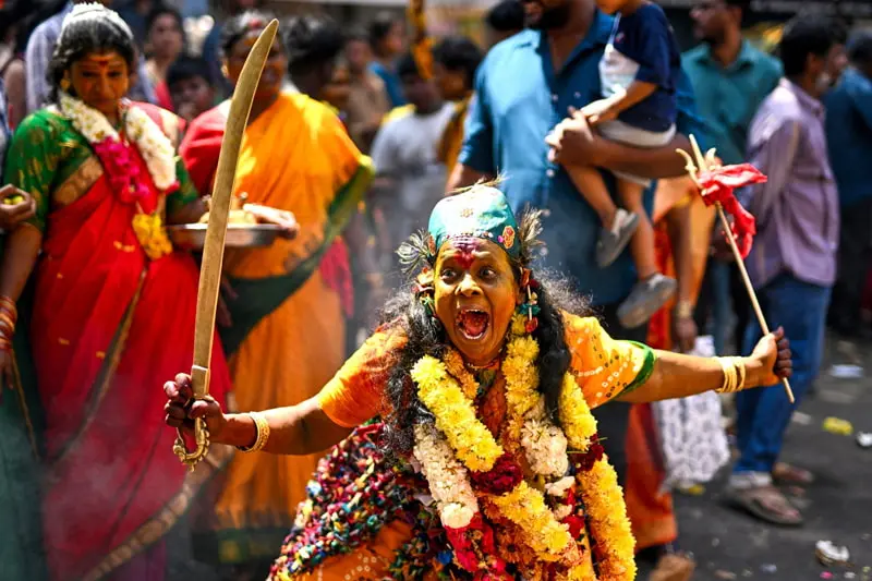 A person in the Hindu god of Kali performing a ritual dance in a religious march during the Maha Shivar Festival in India; Photo Source: Theguardian; Photographer Name: r Satish Babu